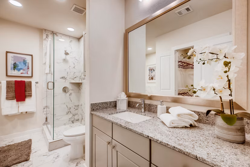 Bathroom featuring sleek fixtures and modern design at The Caroline Apartments