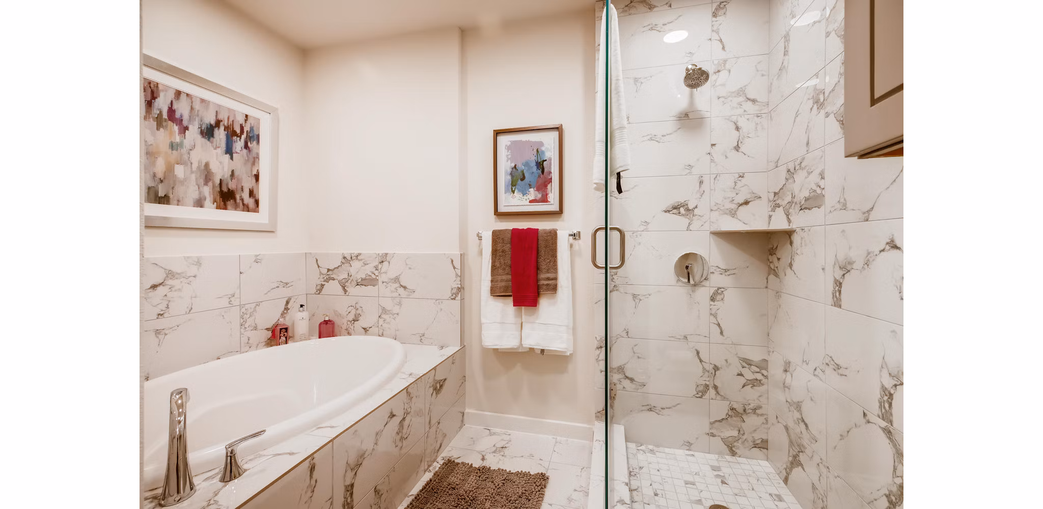 Bathroom with modern fixtures and lighted mirror at The Caroline Apartments