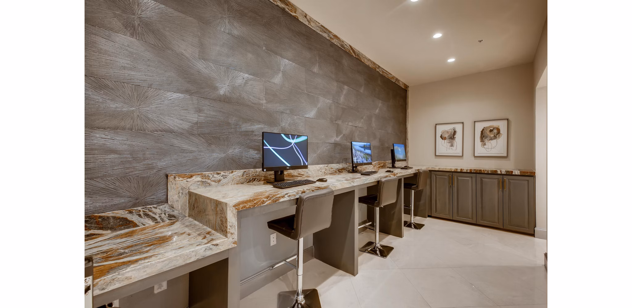 Business center featuring modern workstations at The Caroline Apartments
