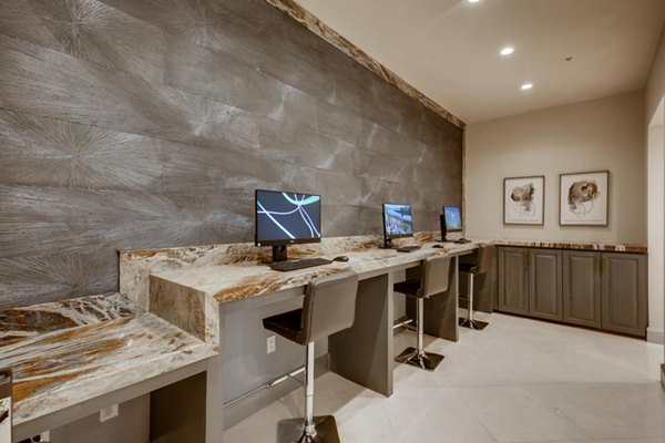 Business center featuring modern workstations at The Caroline Apartments