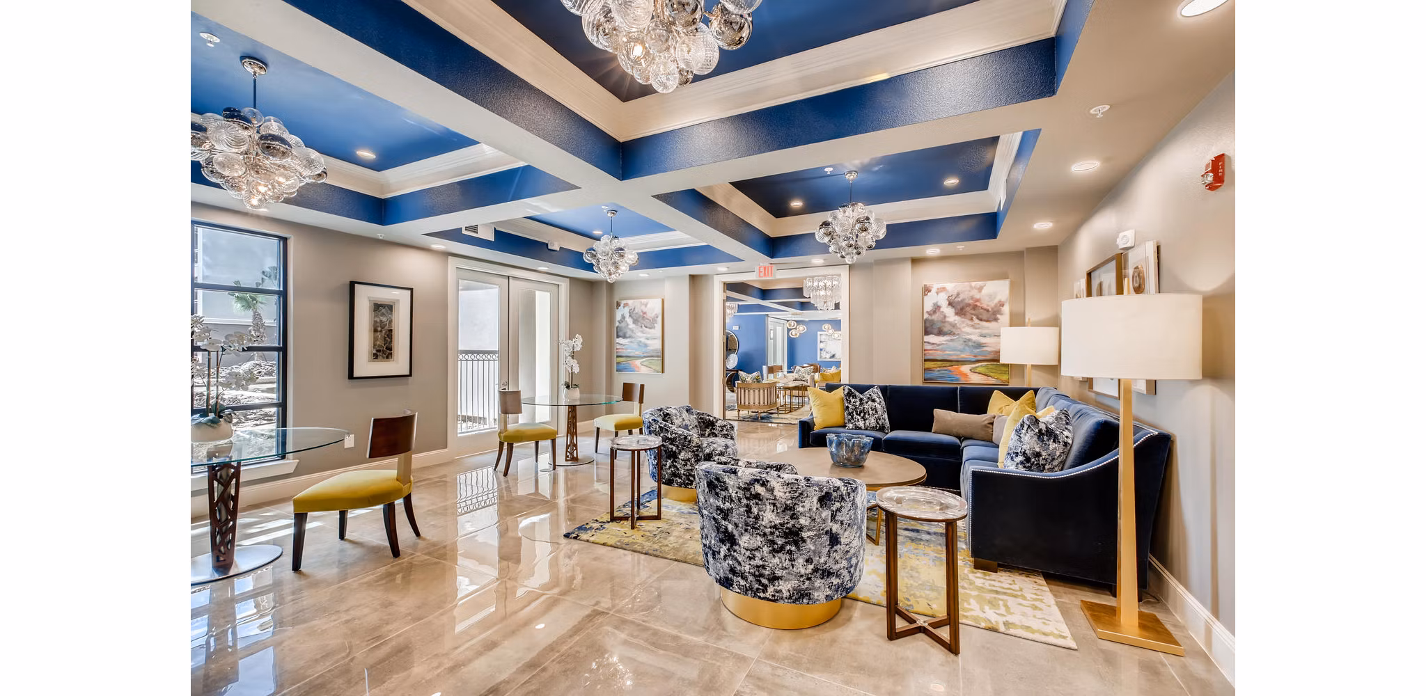 Modern clubhouse featuring cozy seating and billiards at The Caroline Apartments