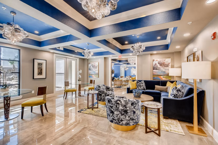 Modern clubhouse featuring cozy seating and billiards at The Caroline Apartments