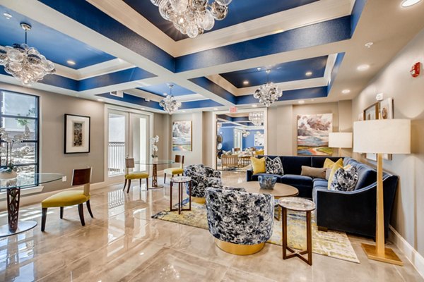 Modern clubhouse featuring cozy seating and billiards at The Caroline Apartments