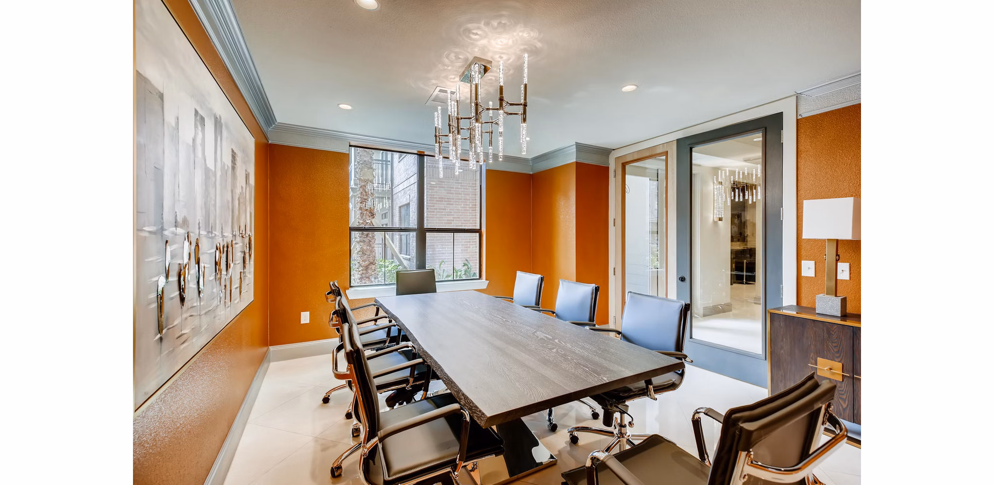 Modern meeting facility with large conference table and chairs at The Caroline Apartments