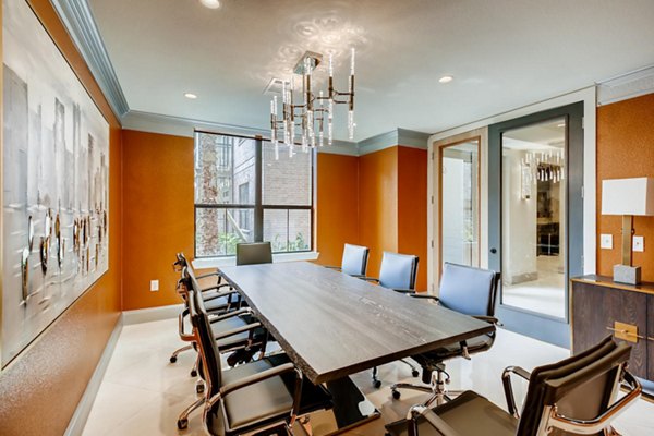 Modern meeting facility with large conference table and chairs at The Caroline Apartments