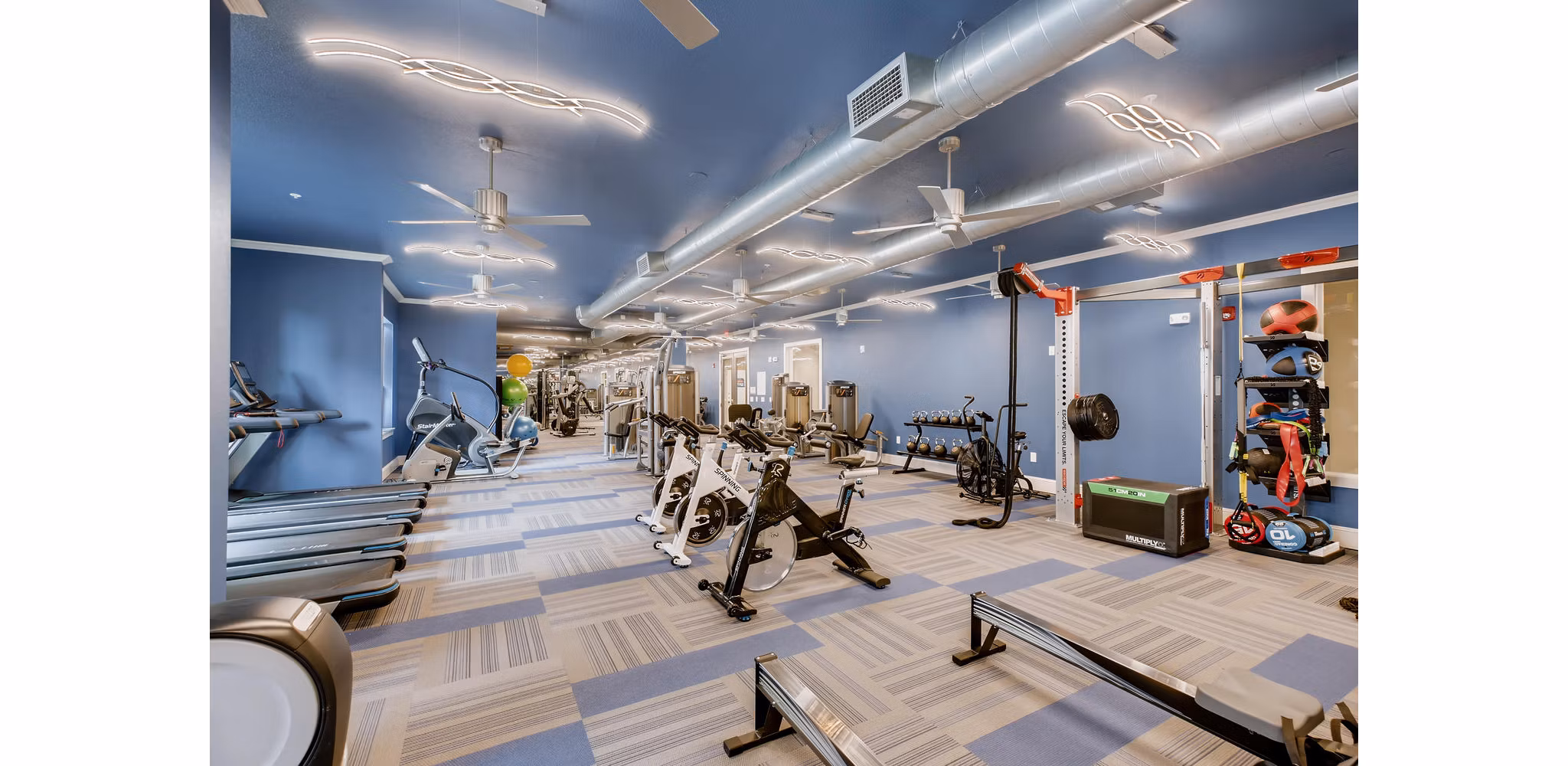 State-of-the-art fitness center at The Caroline Apartments featuring modern equipment for residentsâ€™ wellness and exercise routines