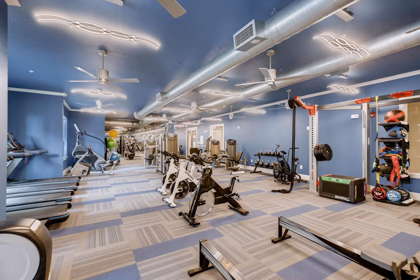 State-of-the-art fitness center at The Caroline Apartments featuring modern equipment for residentsâ€™ wellness and exercise routines
