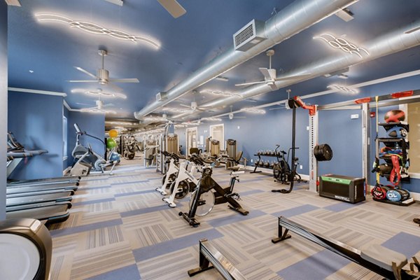 State-of-the-art fitness center at The Caroline Apartments featuring modern equipment for residentsâ€™ wellness and exercise routines
