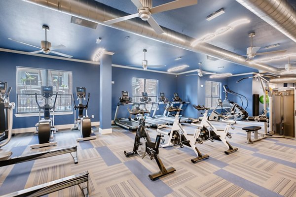 Fully-equipped fitness center with modern machines at The Caroline Apartments