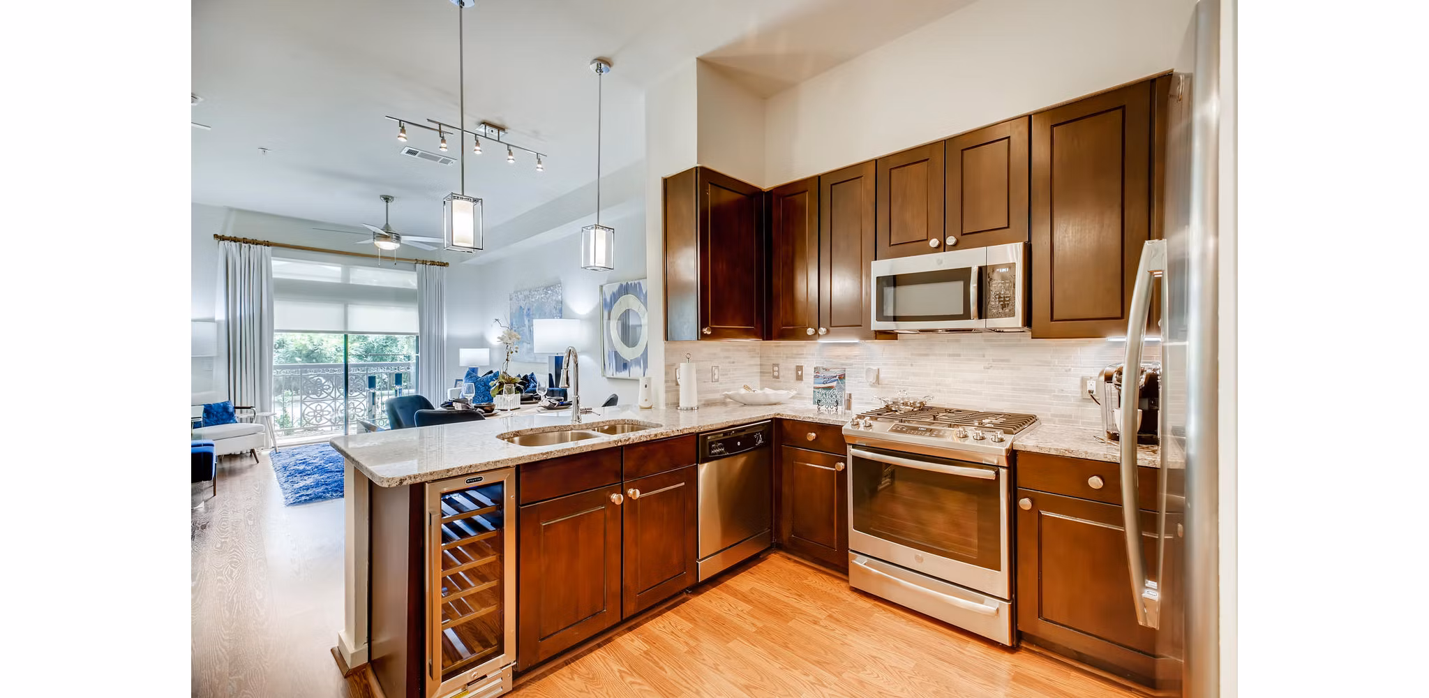 Modern kitchen featuring sleek countertops and stainless steel appliances at The Caroline Apartments