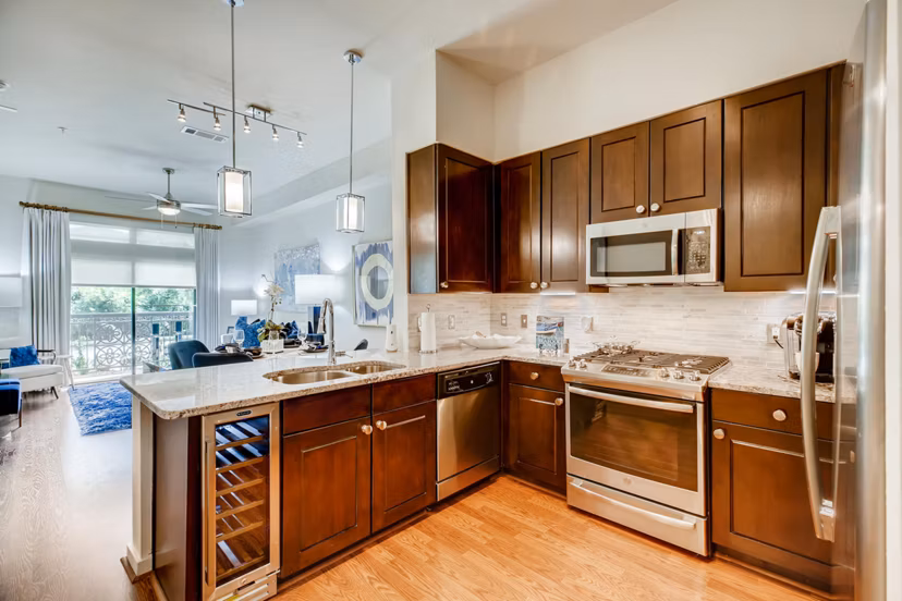 Modern kitchen featuring sleek countertops and stainless steel appliances at The Caroline Apartments