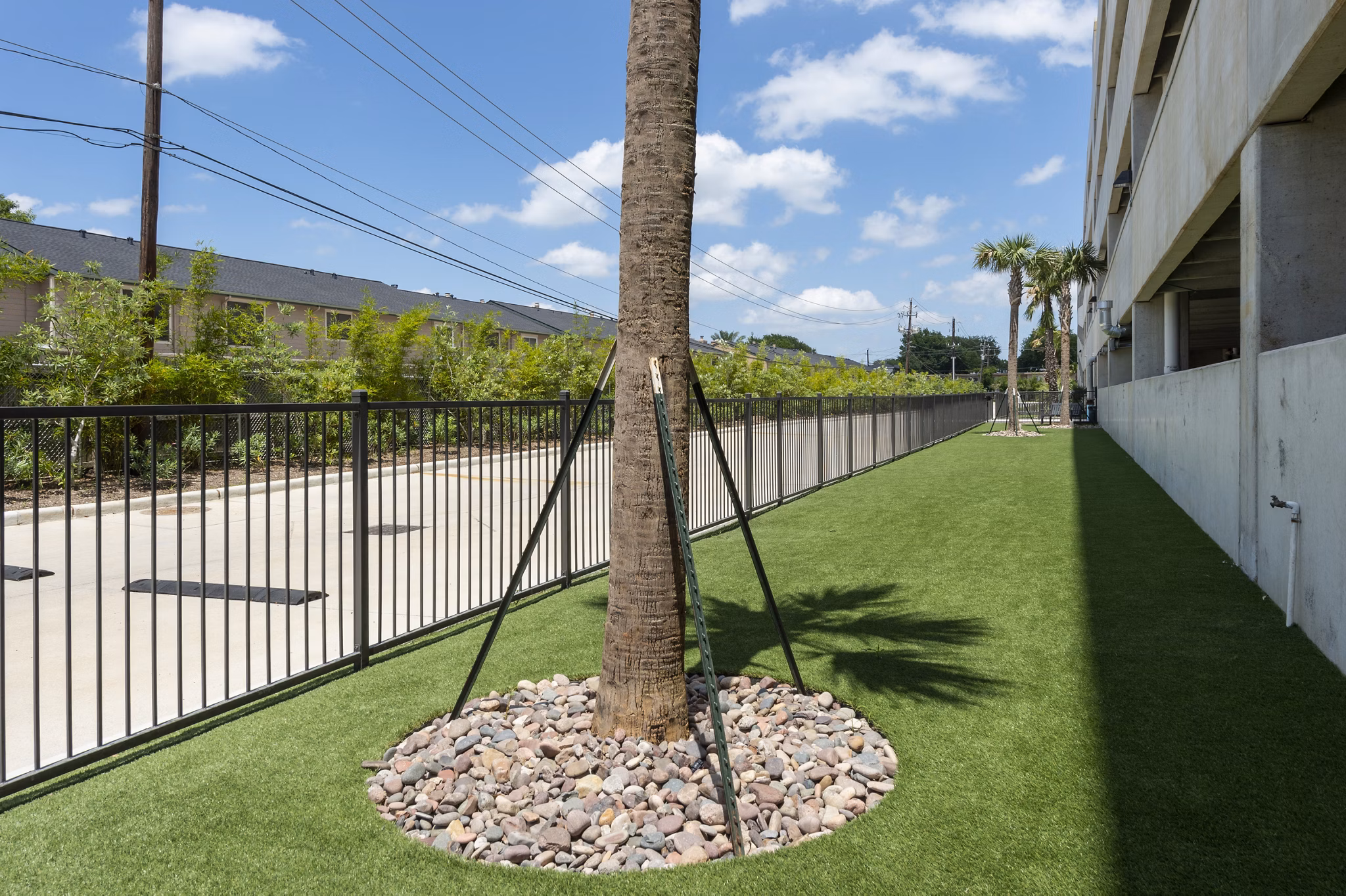 Spacious dog park with agility equipment at The Caroline Apartments, offering a pet-friendly environment for residents and their furry friends