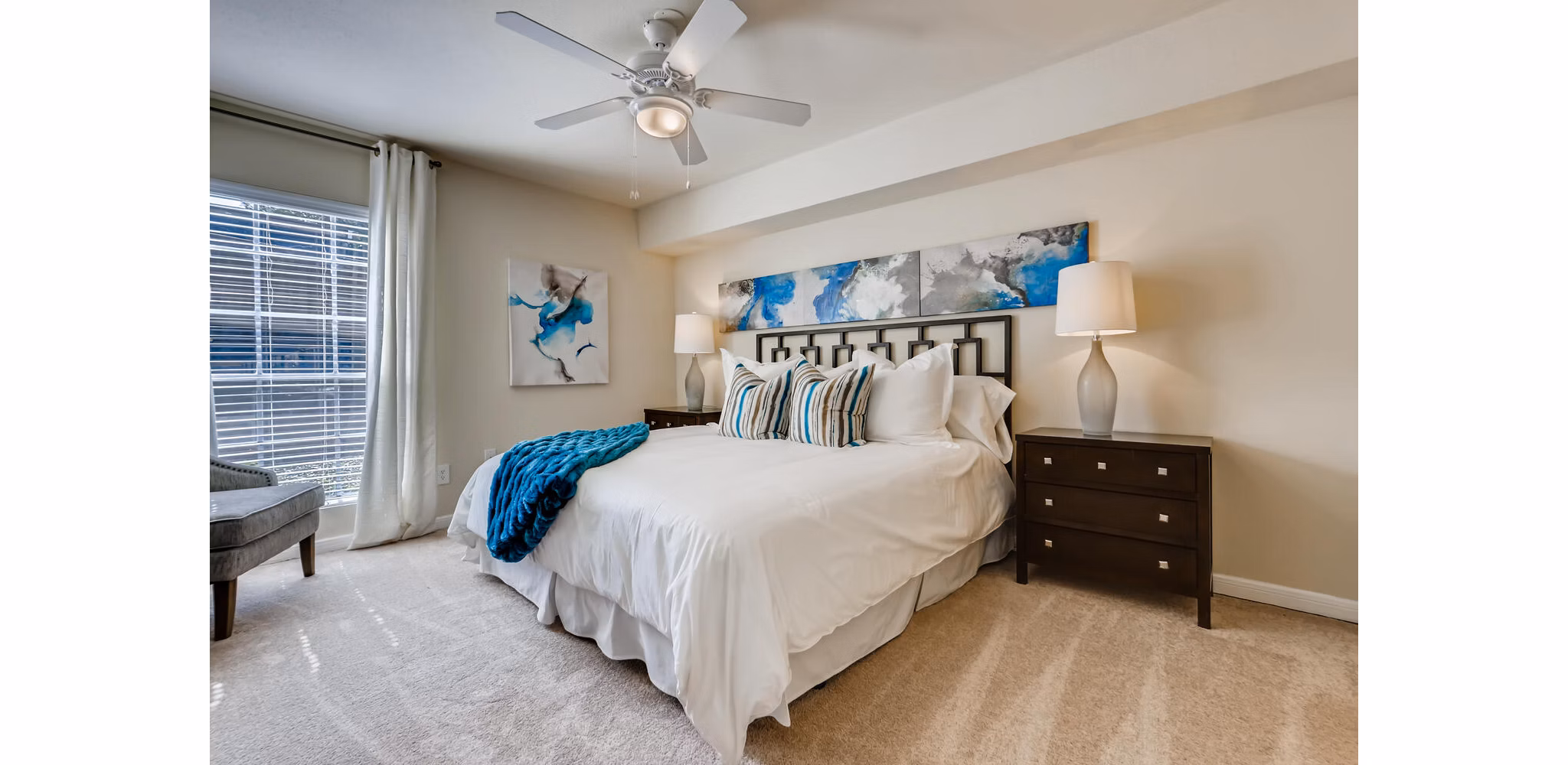 Modern bedroom with spacious layout and natural light at The Creole on Yorktown Apartments
