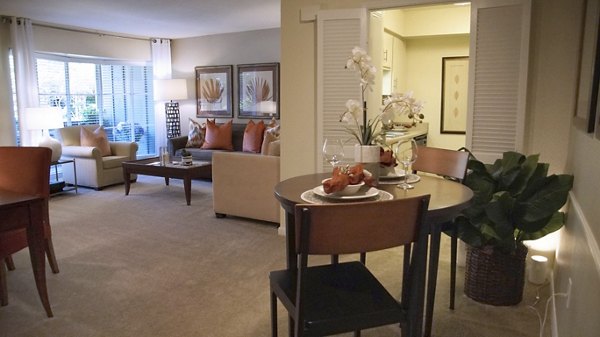 Spacious living room and dining area with modern furnishings in luxury apartments