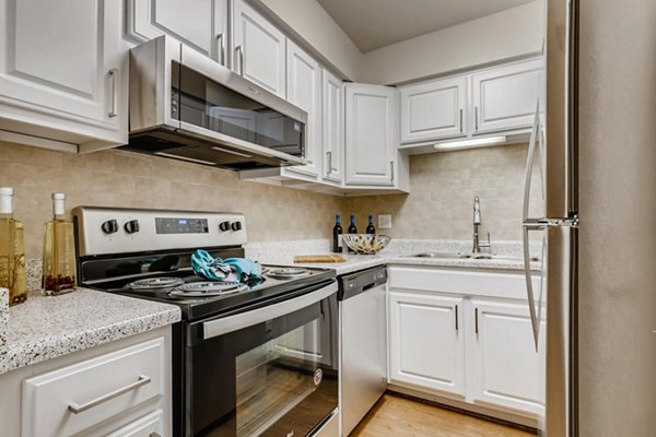 Kitchen featuring modern stainless steel appliances in The Creole on Yorktown Apartments
