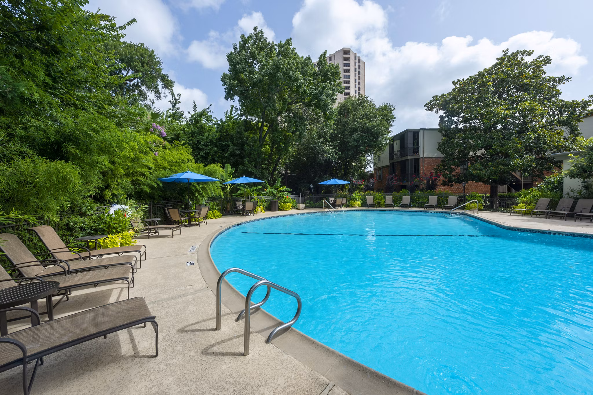 Resort-style pool with lounge chairs at The Creole on Yorktown Apartments