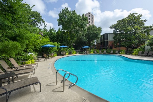 Resort-style pool with lounge chairs at The Creole on Yorktown Apartments