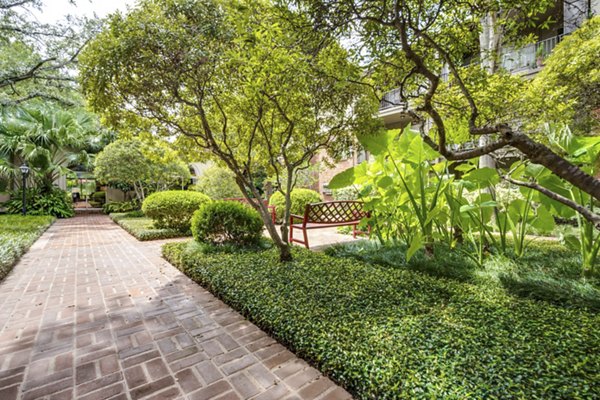The Creole on Yorktown: Tranquil courtyard with lush greenery and seating areas at luxury apartments in a peaceful setting