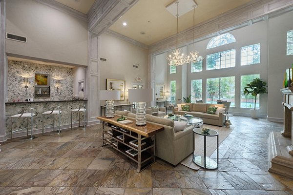 Clubhouse with modern design elements at The Park at Armand Bayou Apartments in Houston, featuring spacious seating and high ceilings