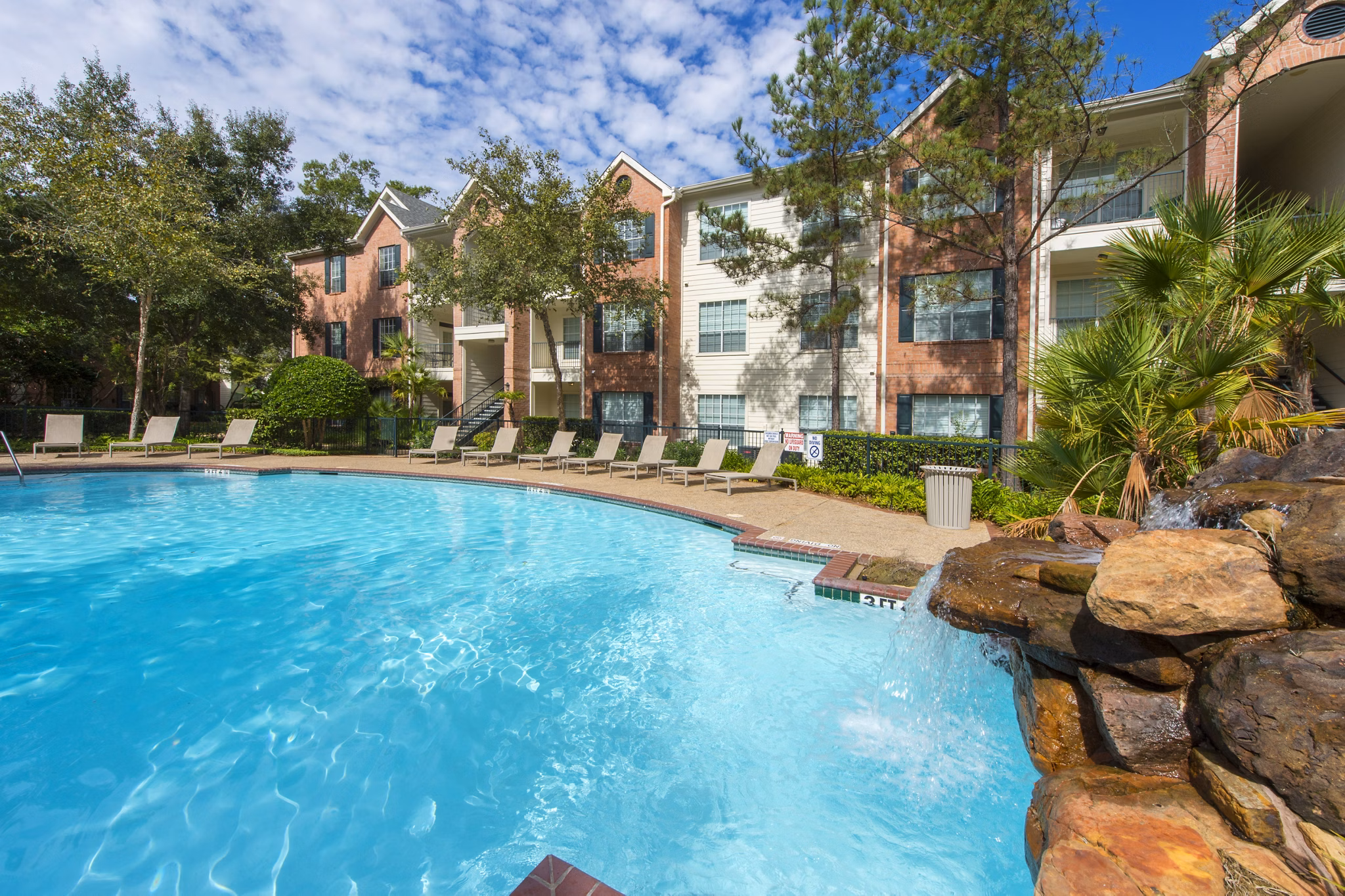 Resort-style pool at The Park at Armand Bayou Apartments offering luxury amenities in a serene environment