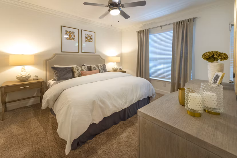 Bedroom with modern decor and large windows at The Park on Memorial Apartments