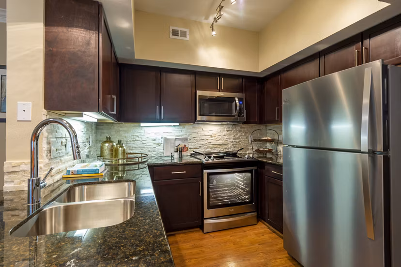 Modern kitchen with stainless steel appliances at The Park on Memorial Apartments