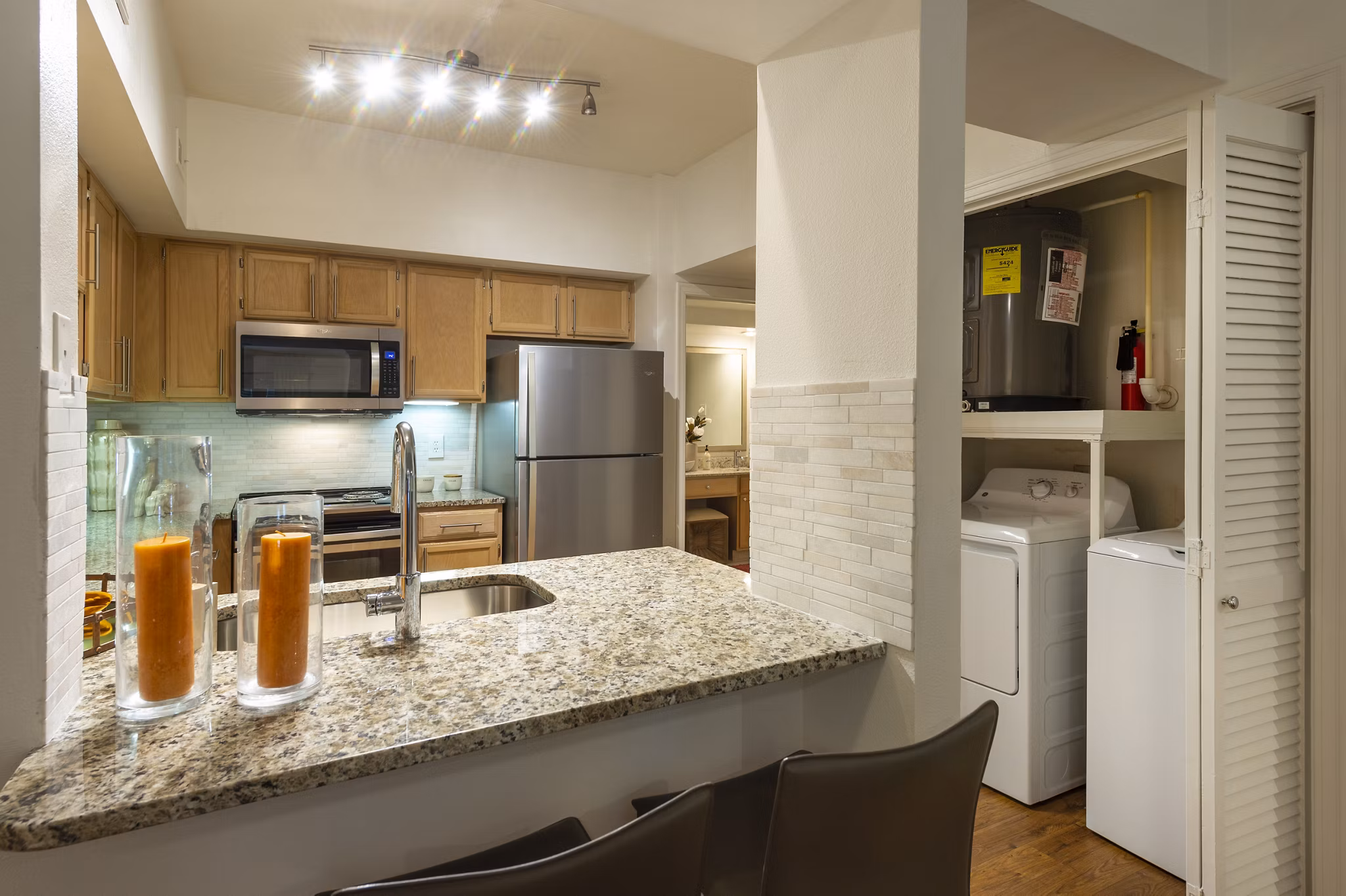 Modern kitchen with stainless steel appliances and granite countertops at The Park on Memorial Apartments