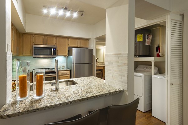 Modern kitchen with stainless steel appliances and granite countertops at The Park on Memorial Apartments