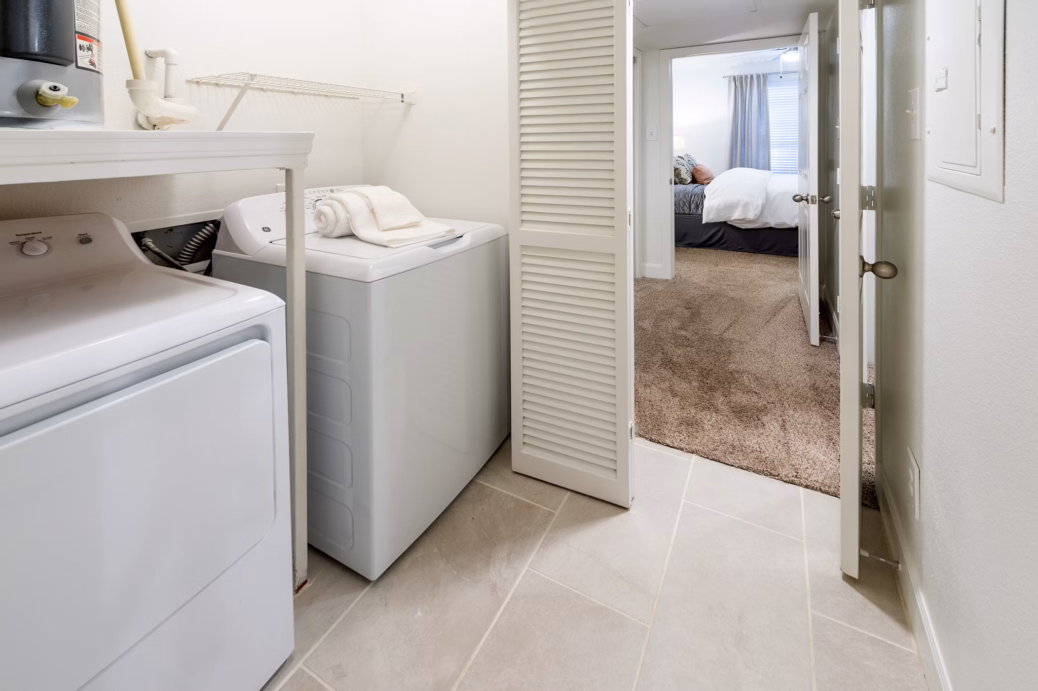 Laundry room with modern appliances at The Park on Memorial Apartments, featuring energy-efficient machines and ample folding space