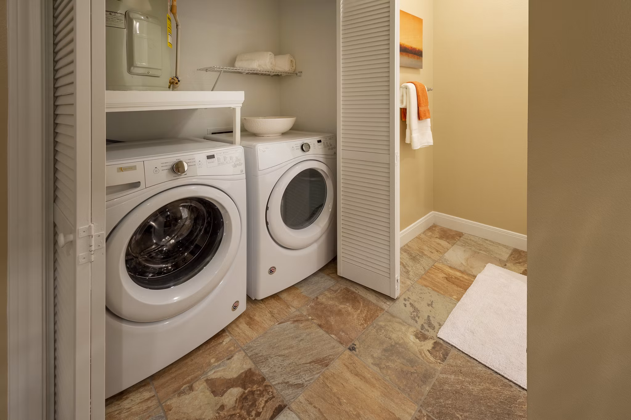 Laundry room with modern appliances at The Park on Memorial Apartments in Houston