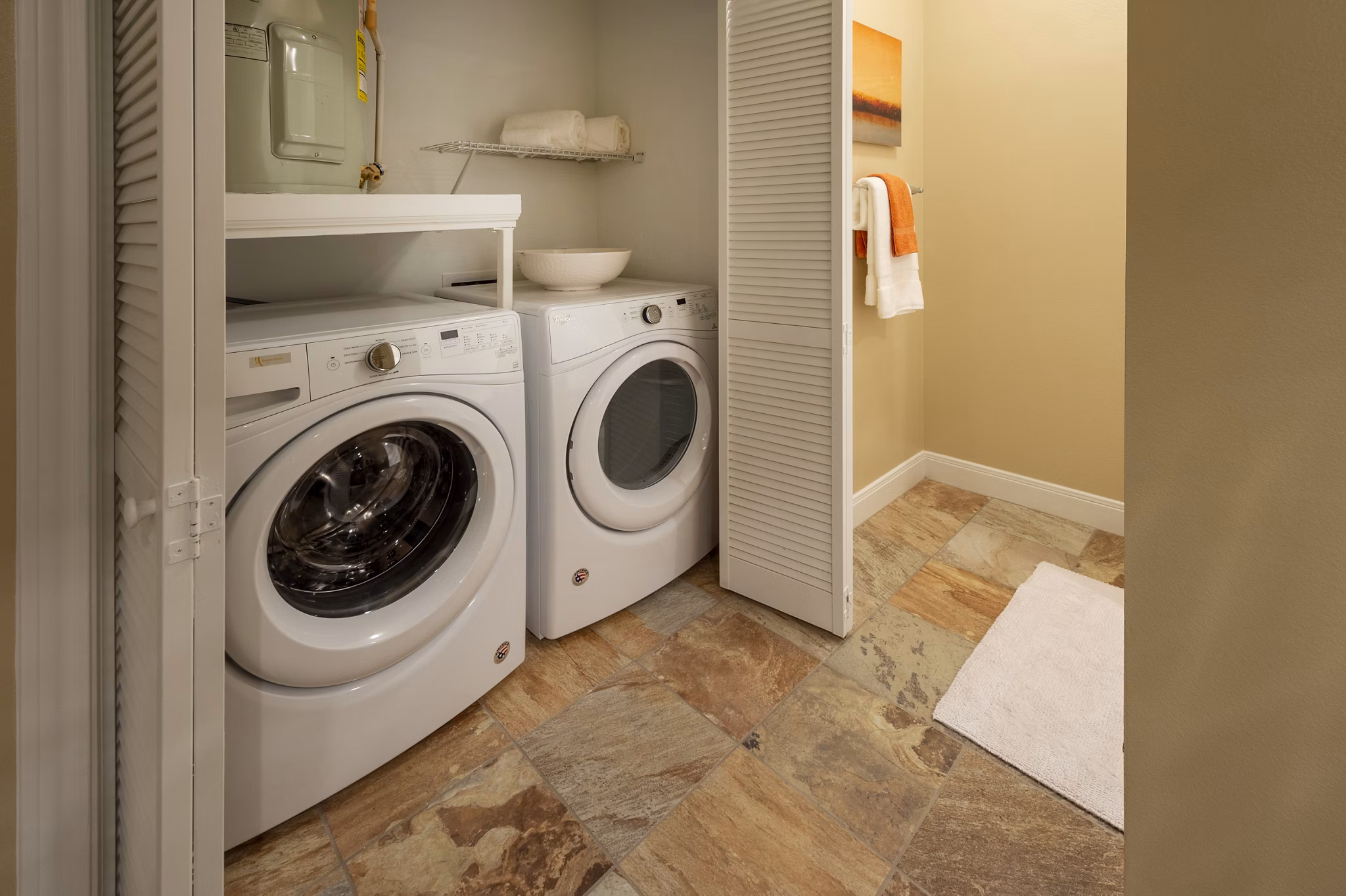 Laundry room with modern appliances at The Park on Memorial Apartments in Houston