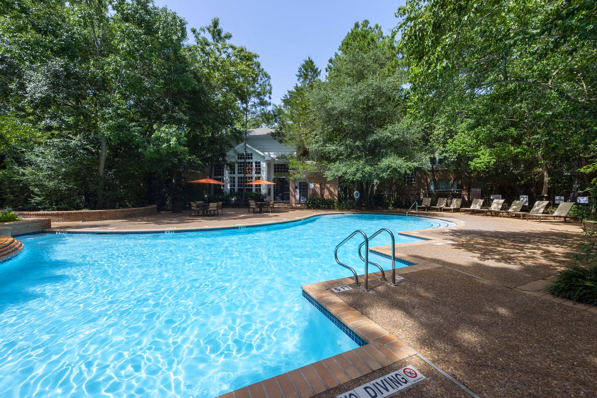 Poolside relaxation at Park on Memorial Apartments, featuring a luxurious outdoor pool area perfect for unwinding and leisure activities