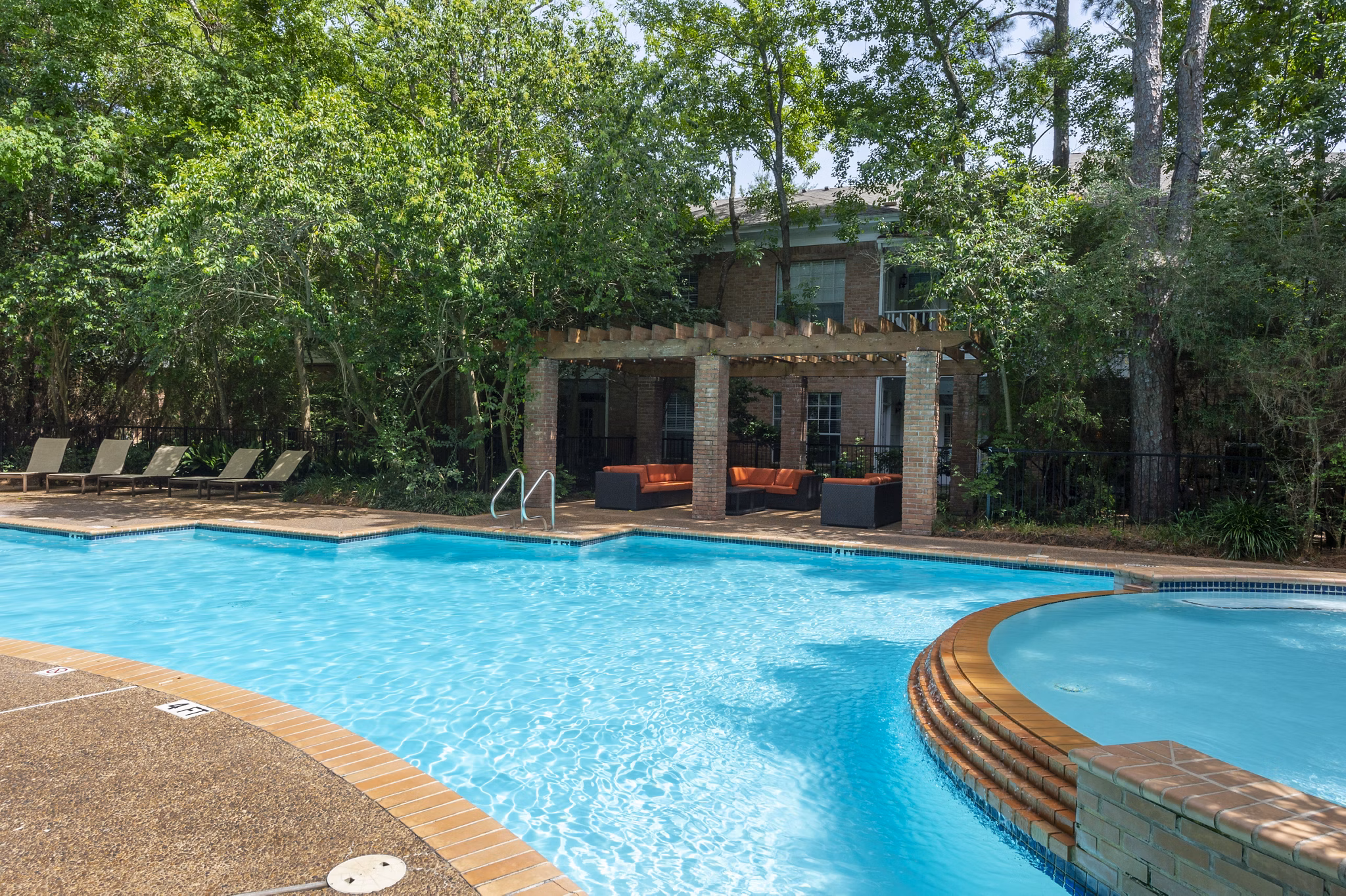 Resort-style pool with loungers at The Park on Memorial Apartments