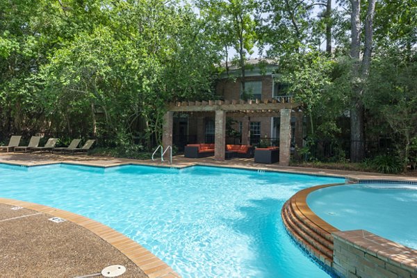Resort-style pool with loungers at The Park on Memorial Apartments