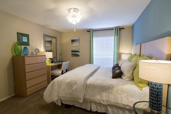 Cozy bedroom with modern decor at The Pines of Woodforest Apartments