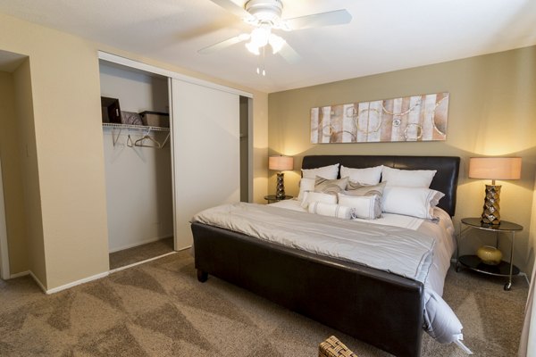 Cozy bedroom with modern decor at The Pines of Woodforest Apartments