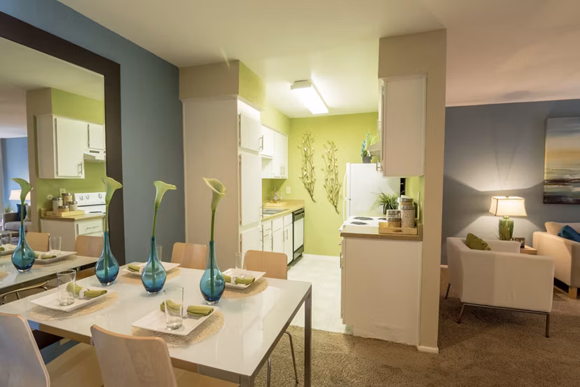 Dining area featuring elegant wooden furniture and modern lighting at The Pines of Woodforest Apartments