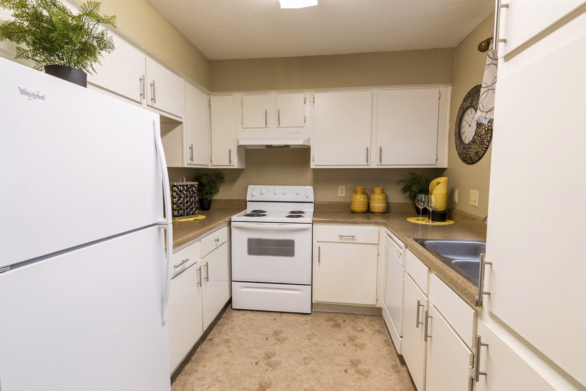 Modern kitchen featuring granite countertops and stainless steel appliances at The Pines of Woodforest Apartments