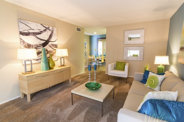 Living room featuring cozy seating and modern decor at The Pines of Woodforest Apartments, luxury living near shopping in a tranquil setting