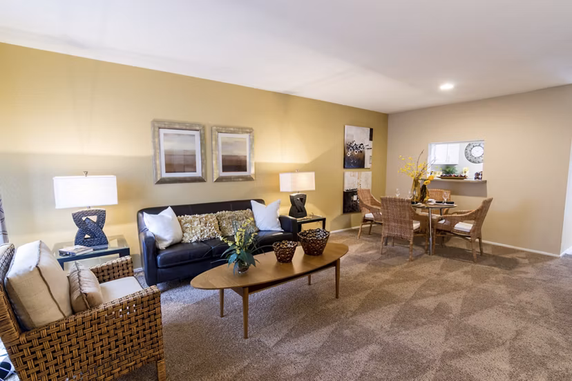 Living room with plush seating and modern decor at The Pines of Woodforest Apartments, offering a cozy retreat in a luxurious setting