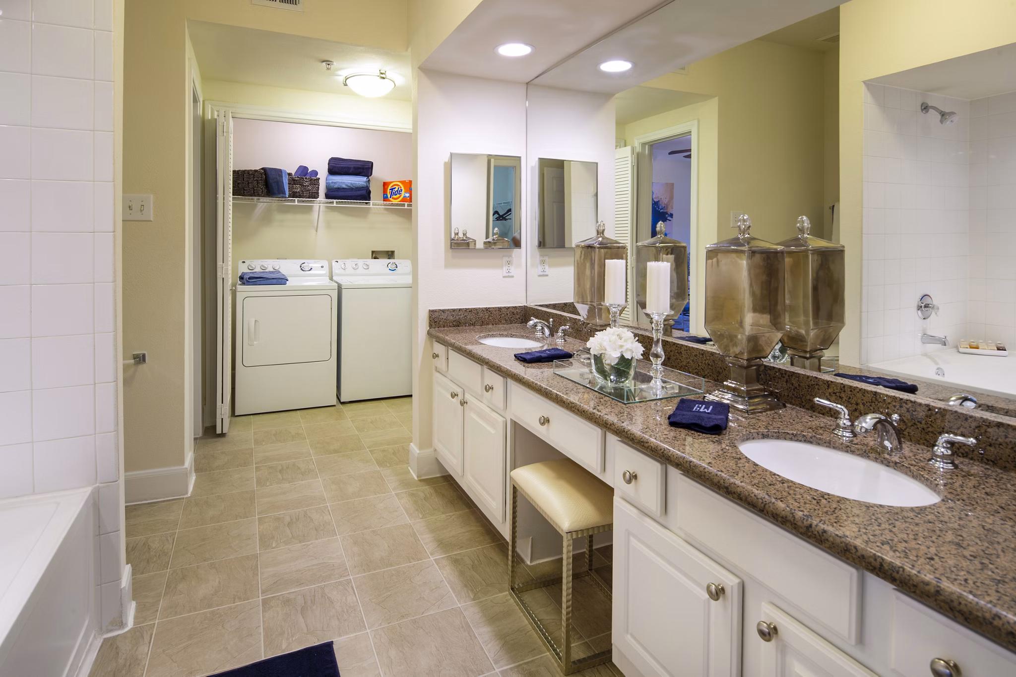 Elegant bathroom featuring marble countertops and glass-enclosed shower at The Post Oak at Woodway Apartments