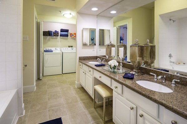 Elegant bathroom featuring marble countertops and glass-enclosed shower at The Post Oak at Woodway Apartments