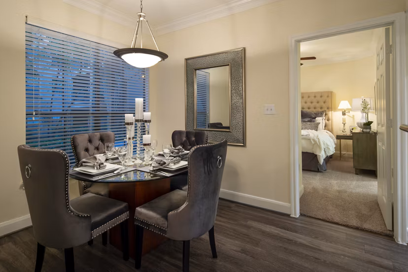 Dining area featuring modern furnishings and elegant lighting at The Post Oak at Woodway Apartments