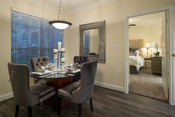 Dining area featuring modern furnishings and elegant lighting at The Post Oak at Woodway Apartments