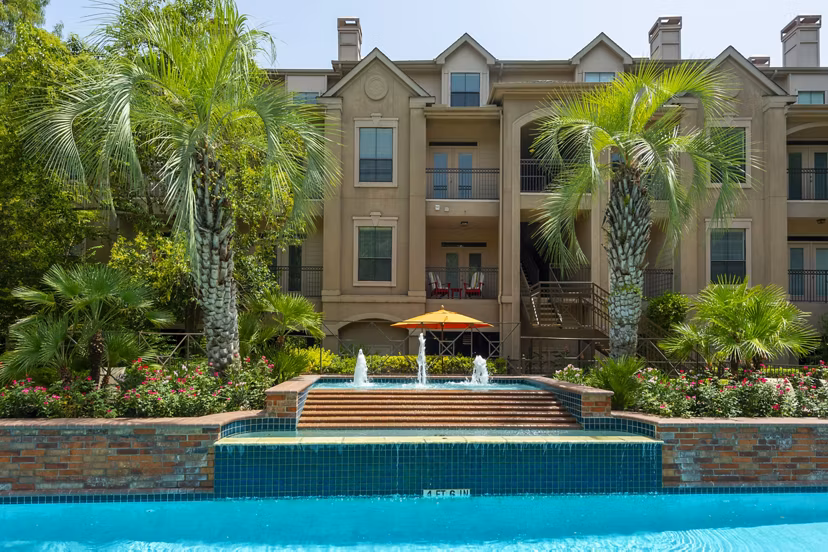 Rooftop pool with skyline view at The Post Oak at Woodway Apartments