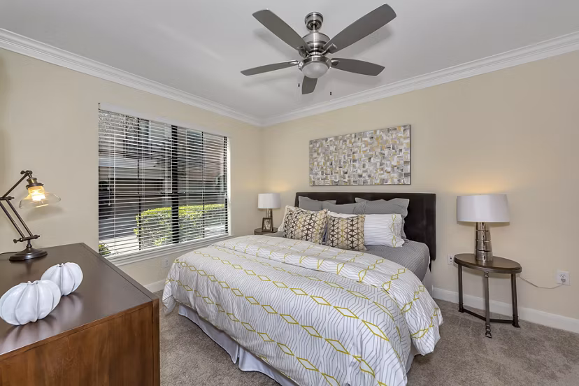 Bedroom featuring elegant decor and plush bedding at Renaissance at Preston Hollow Apartments