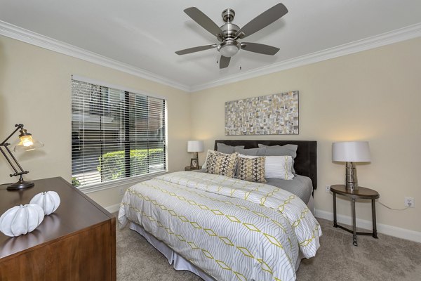 Bedroom featuring elegant decor and plush bedding at Renaissance at Preston Hollow Apartments