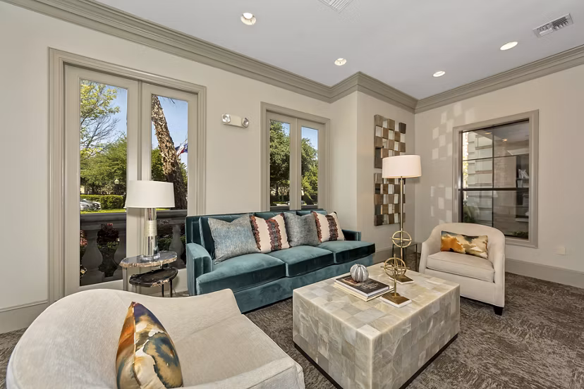 Clubhouse with elegant furnishings and ample seating at Renaissance at Preston Hollow Apartments, offering a luxurious social space