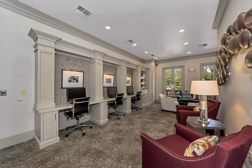 Business center with modern desks and computers at Renaissance at Preston Hollow Apartments, luxury living spaces in Dallas