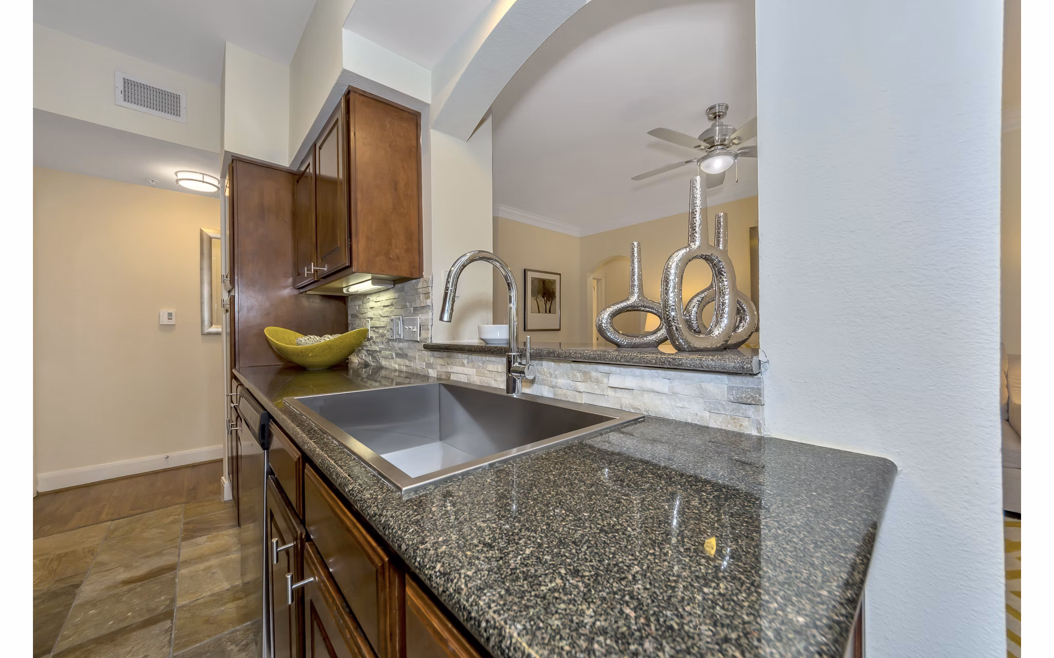 Modern kitchen with stainless steel appliances at Renaissance at Preston Hollow Apartments